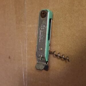 Vintage can opener with cork screw